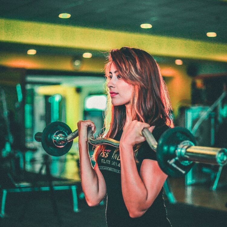 A woman is working out in the gym.