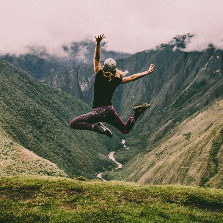 A person is jumping on a hill.