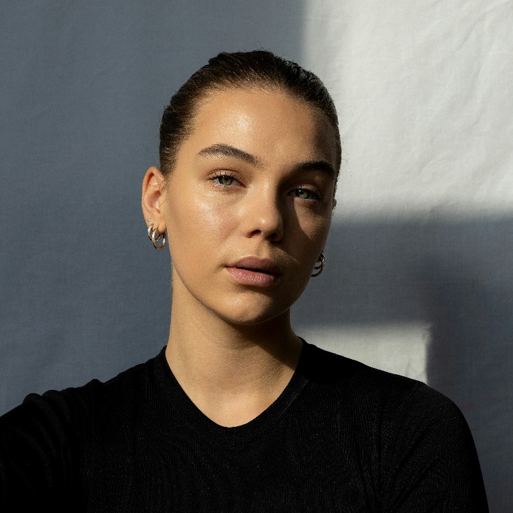 A young woman in a black blouse.